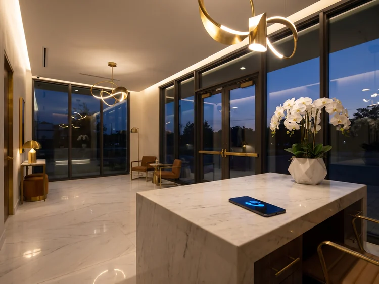 Luxury med spa reception at dusk with a phone glowing on the desk